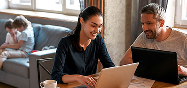 Young married couple with children reviewing their credit score.